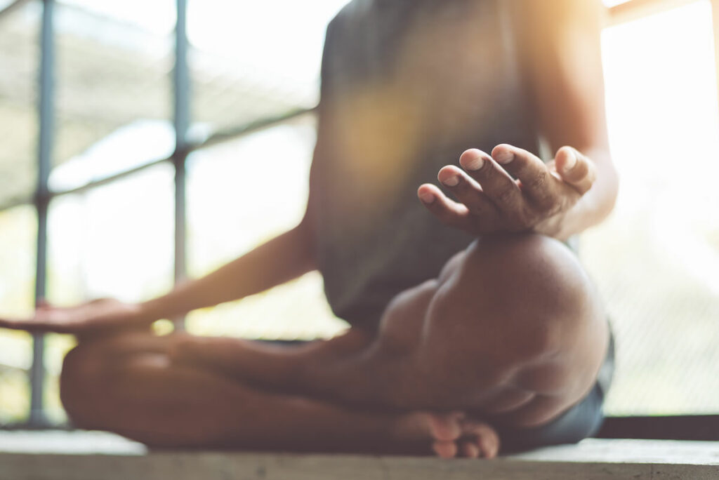 man practicing meditation for wellness